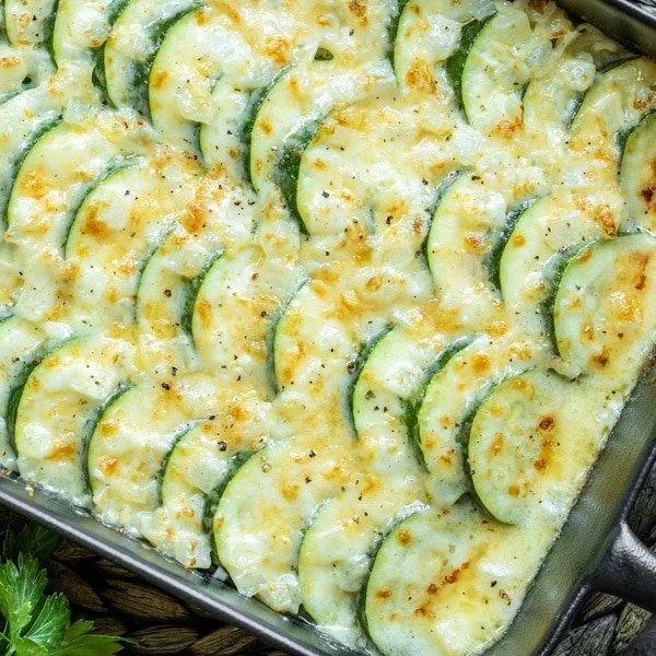 Cheesy Zucchini Bake Casserole topped with melted cheese and fresh herbs