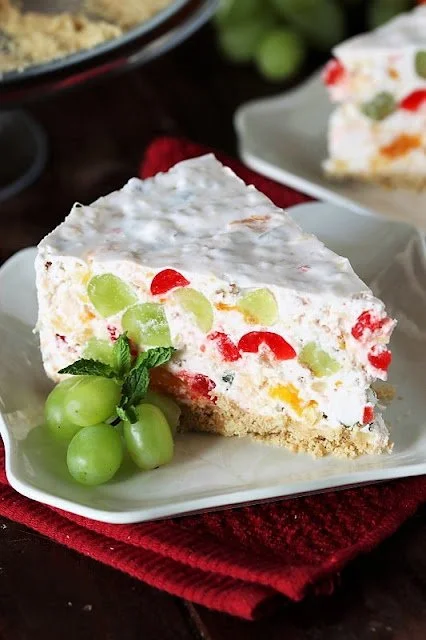 Creamy cheesecake topped with colorful fruit salad