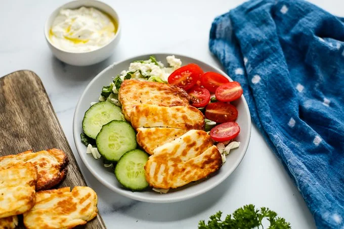 Crispy air fryer halloumi served on a plate with dipping sauce