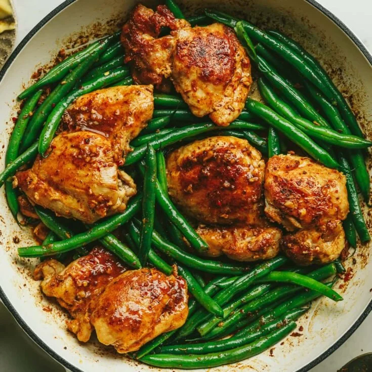 Skillet Lemon Garlic Butter Chicken served with fresh herbs and lemon slices