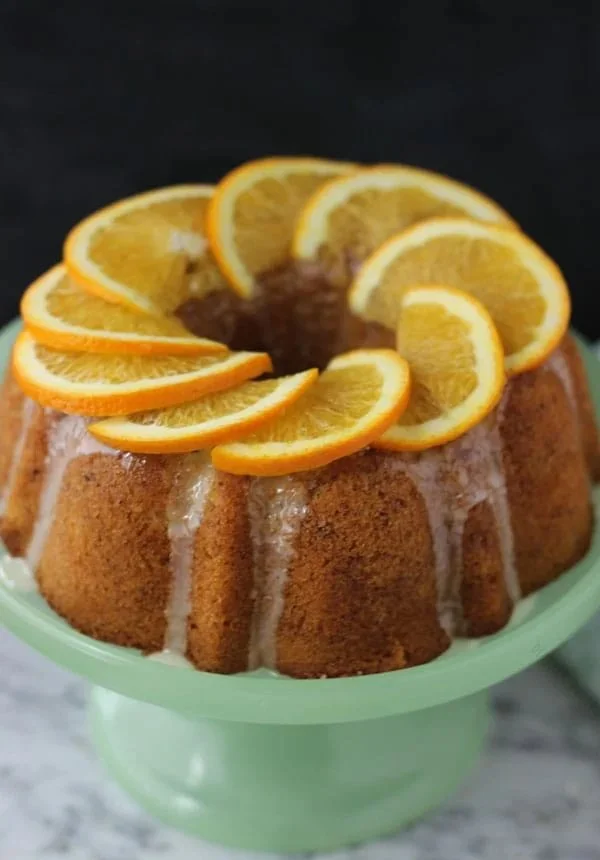 A delicious slice of Orange Zest Hazelnut Cake garnished with orange peel