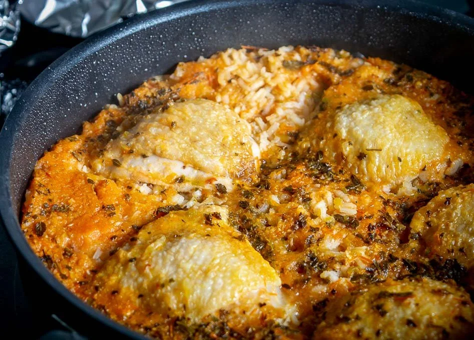 Delicious plate of tangy Mexican chicken and rice garnished with fresh herbs